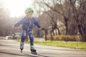 Beautiful sport baby. Active childhood. The boy is wearing a helmet.