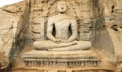 Fototapeta na wymiar Stunning view of the beautiful Samadhi statue carved in stone. The Samadhi Statue is a statue situated at Mahamevnawa Park in Anuradhapura, Sri Lanka.