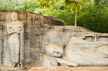 Beautiful statue of the Reclining Buddha and Monk Ananda carved in stone. The Gal Vihara also known as Gal Viharaya is a rock temple situated in the ancient city of Polonnaruwa, Sri Lanka.