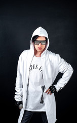 guy in black glasses on a dark background of concrete in the studio, positioning in the studio of a young guy in black glasses