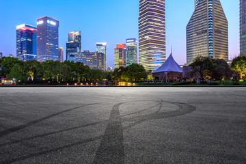 Asphalt race track and modern skyline and buildings in Shanghai at night