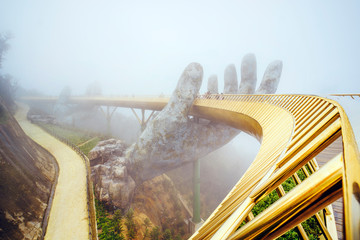 Danang , Vietnam. View in Fog of the Golden Bridge on Ba Na Hills in Da Nang on rainy day