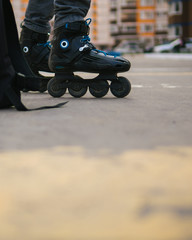 Fototapeta na wymiar Close-up of roller skates on feet . Man on roller skates