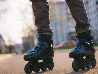 Close-up of roller skates on feet . Man on roller skates