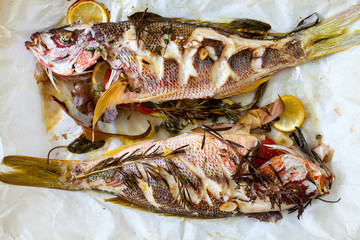 Roast red snappers with lemon, rosemary and garlic