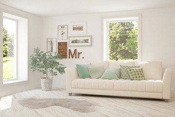 Fototapeta premium Stylish room in white color with sofa and summer landscape in window. Scandinavian interior design. 3D illustration