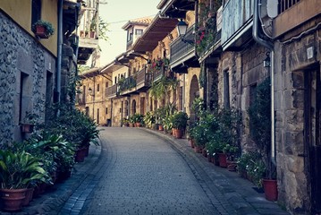 Fototapeta na wymiar Narrow stone street in the small medieval village of Cartes, Spain