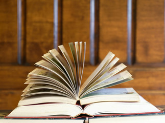 Education concept, book with open textbook on top of books