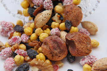 Sweet dried fruits and nuts in a crystal vase.