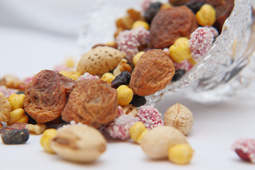Sweet dried fruits and nuts in a crystal vase.