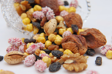 Sweet dried fruits and nuts in a crystal vase.