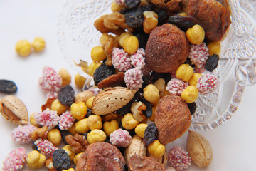Fototapeta premium Sweet dried fruits and nuts in a crystal vase.