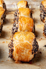 Crispy freshly baked cookies with poppy seeds on a baking tray.