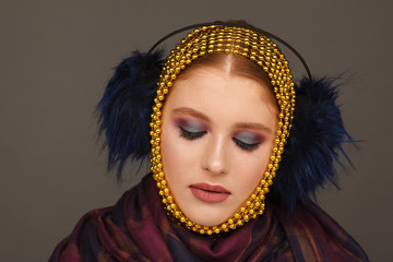 Creative portrait of an interesting woman in an unusual style using chaplet. Studio photo session