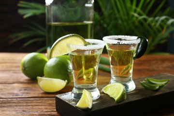 Shots of tequila on wooden table