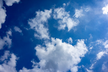 White clouds of fancy shape againstblue sky on clear sunny day. Beautiful unique look. Concept of nature of North Caucasus for design.
