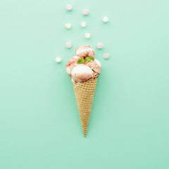 Ice cream in waffle cone with syrup and marshmallow