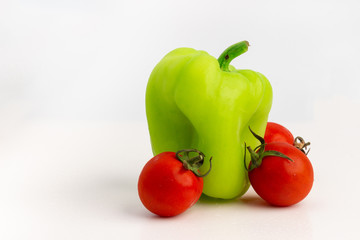 Green pepper and tomatoes isolated on white background