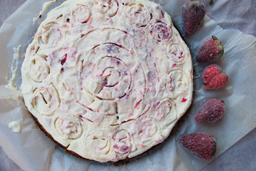 Homemade cheese cake with frozen strawberries.