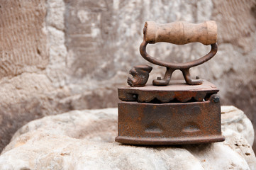 Ancient metal iron with wooden handle