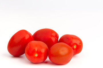 Closeup capture of fresh cherry tomatoes isolated on white background