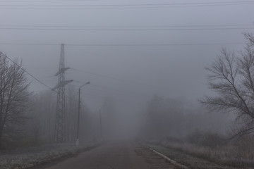 Fototapeta na wymiar High-voltage pole in the mist