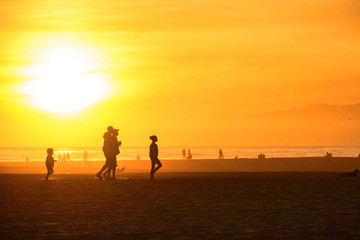 Fototapeta na wymiar Silhouette people enjoy sunset beach at Santa Monica California, USA