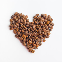 Coffee beans in heart shape on white background