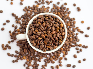 Fototapeta premium Coffee beans in white cup isolated on white background, drinks concept. top view