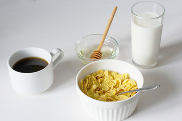 Healthy breakfast with cornflakes and milk over white background