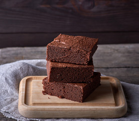 stack of baked square pieces of chocolate brownie cake