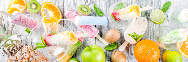 Colorful fruit ice cream popsicle. Juicy gelato lollypops on sticks, with different fresh tropic...