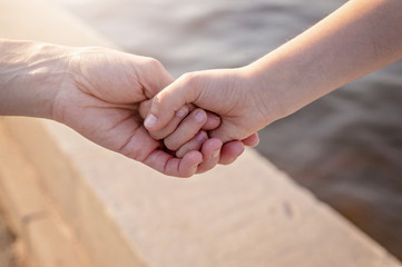 Mom holds her daughter's hand. Happy family concept