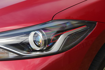 Obraz na płótnie Canvas Red vehicle headlight with details