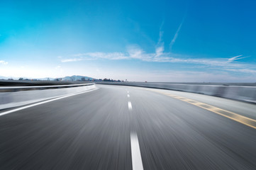 Fototapeta premium Motion-blurred highway in dusk clouds 