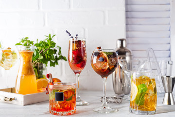 Selection of colorful festive drinks, alcoholic beverages and cocktails in elegant glasses on a white background
