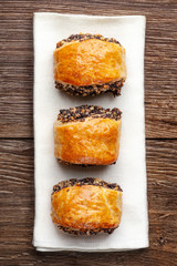 Crispy freshly baked cookies with poppy seeds on a wooden background.