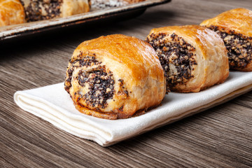 Crispy freshly baked cookies with poppy seeds on a wooden background.