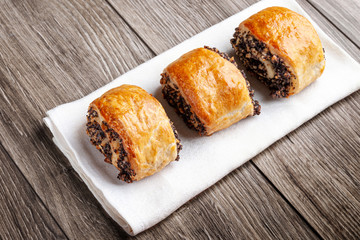 Crispy freshly baked cookies with poppy seeds on a wooden background.