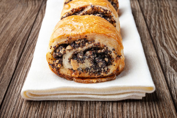 Crispy freshly baked cookies with poppy seeds on a wooden background.