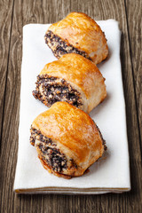 Crispy freshly baked cookies with poppy seeds on a wooden background.