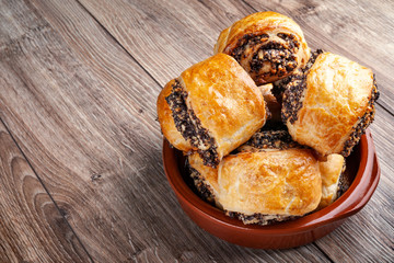Crispy freshly baked cookies with poppy seeds on a wooden background.