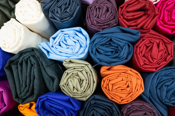 Fototapeta na wymiar background of colorful fabric stacks