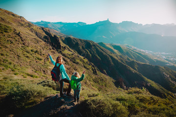 Fototapeta premium happy mother with little daughter travel in mountains