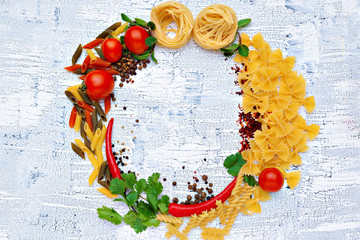 Pasta and ingredients on wooden background with copy space. Top view.