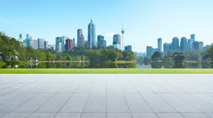 Empty floor with park and modern cityscape . Morning scene .