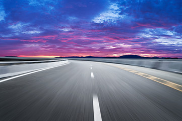 Motion-blurred highway in dusk clouds	