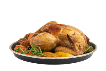 Roasted chicken, potatoes and vegetables in plate isolated on white background. Side view