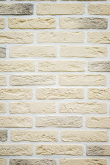 Decorative surface of a wall trimmed by an imitation of a stone and a brick.