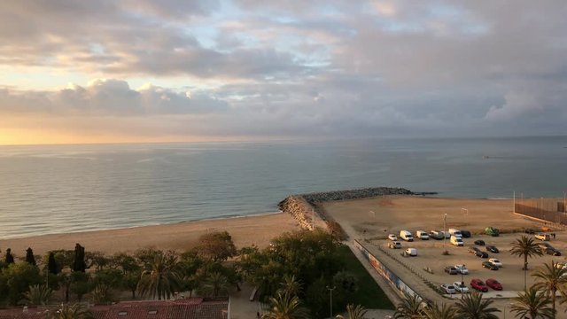 Balcony view of beach at sunrise in Mataro, Barcelona, Spain.